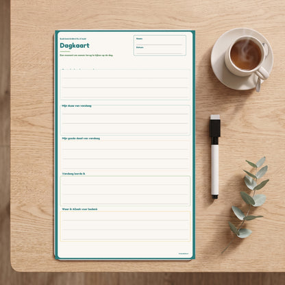Dagkaart magneetplanner op tafel met marker en een kop thee